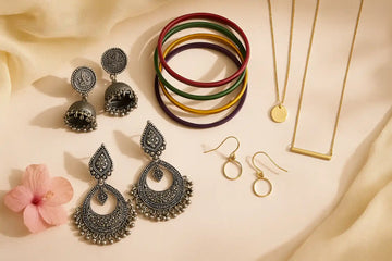 Stylish Winter Wedding Jewellery flatlay showing ethnic silver earrings, bright bangles, and minimalist gold jewellery for festive occasions.